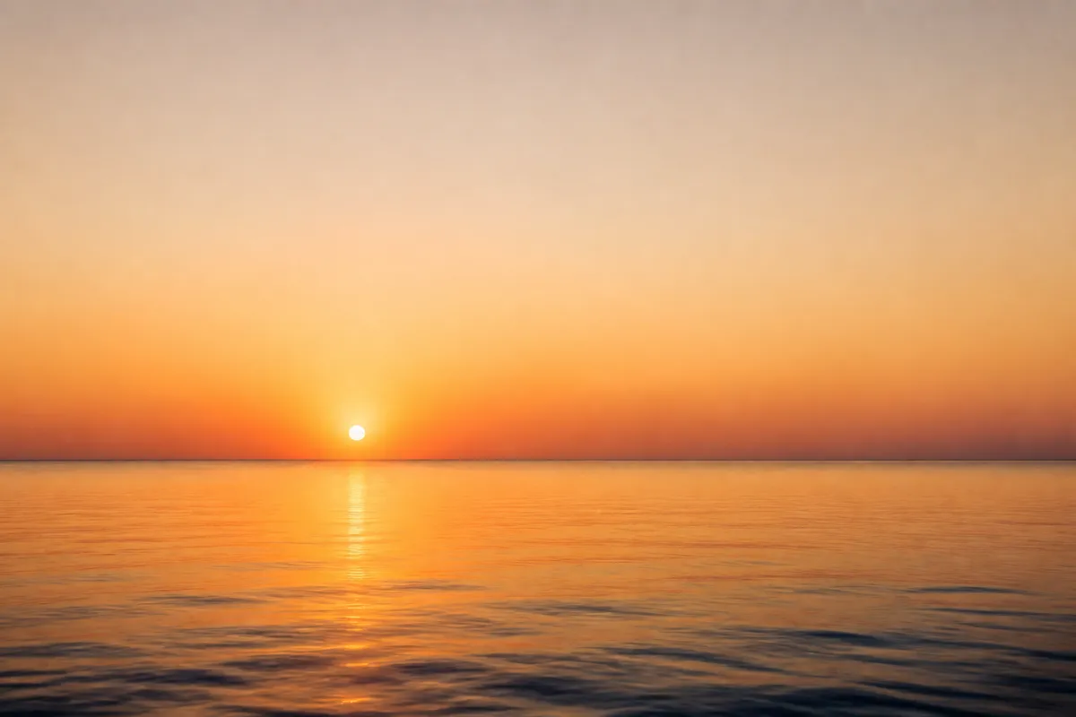 A low midday sun over a horizon, marking the short window below the burn line that makes vitamin D.